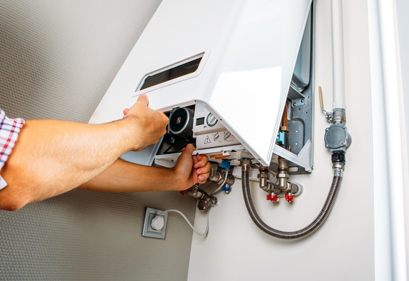 Plumber Attaches Trying Fix Problem With Residential Heating Equipment Repair Gas Boiler